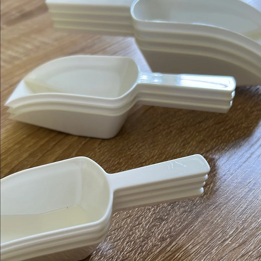 Stack of White Plastic Scoops - 11 pieces